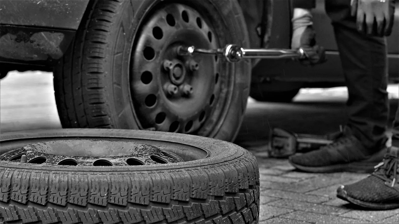 winter tires, tire service, tire, automobile, tyres, car tire, rubber, security, tire profile, nature, vehicles, snow, tire disposal, second hand, season, power, screws, nuts, man, rims, assembly, assemble, black-and-white, hands, tool. Canadian winter prep compared with US northern shop practice